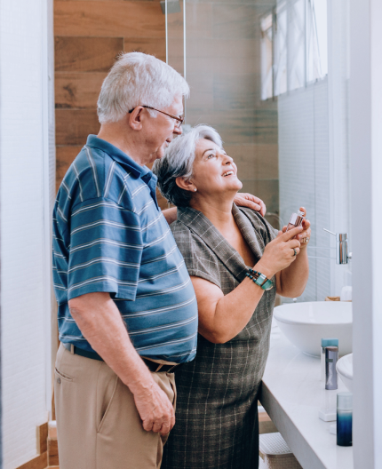 aging couple standing in bathroom